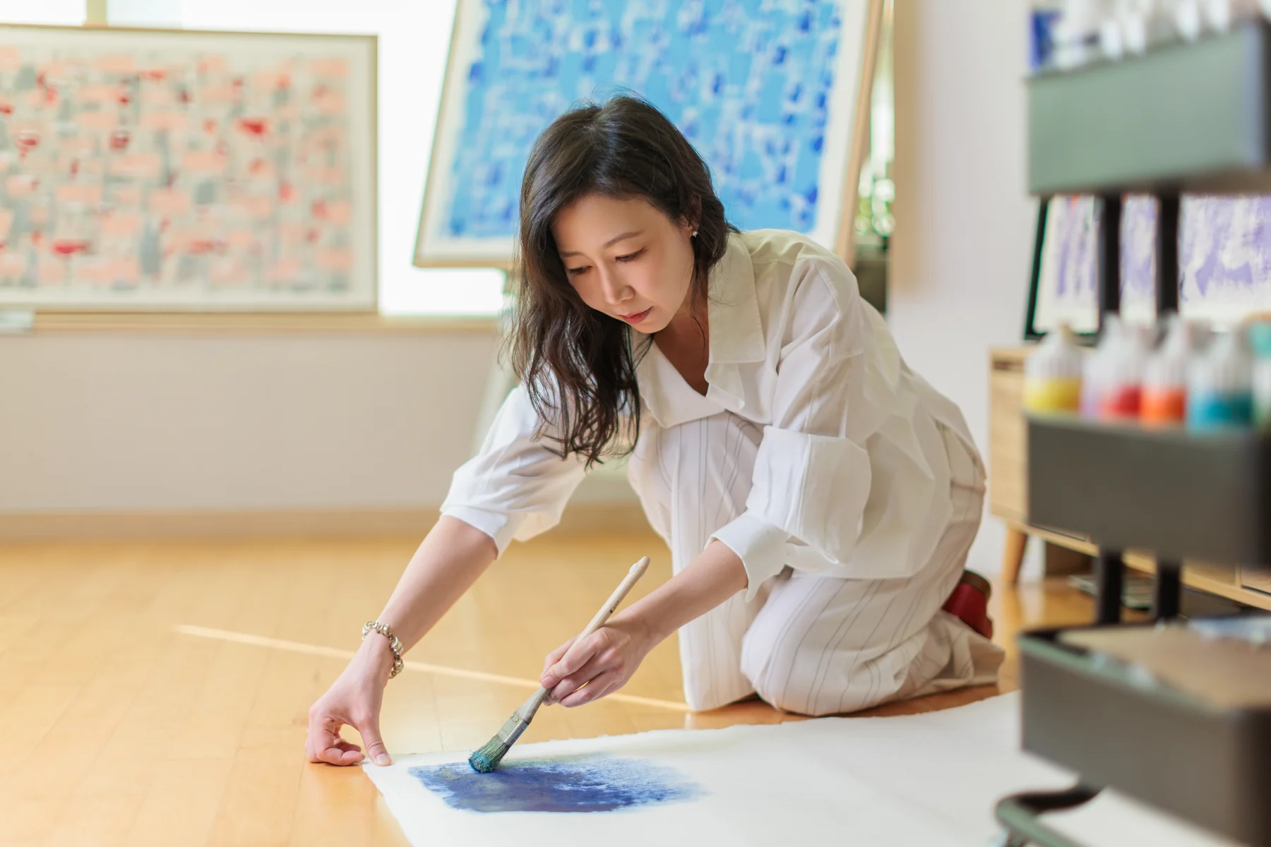 Eunju Park painting in her studio